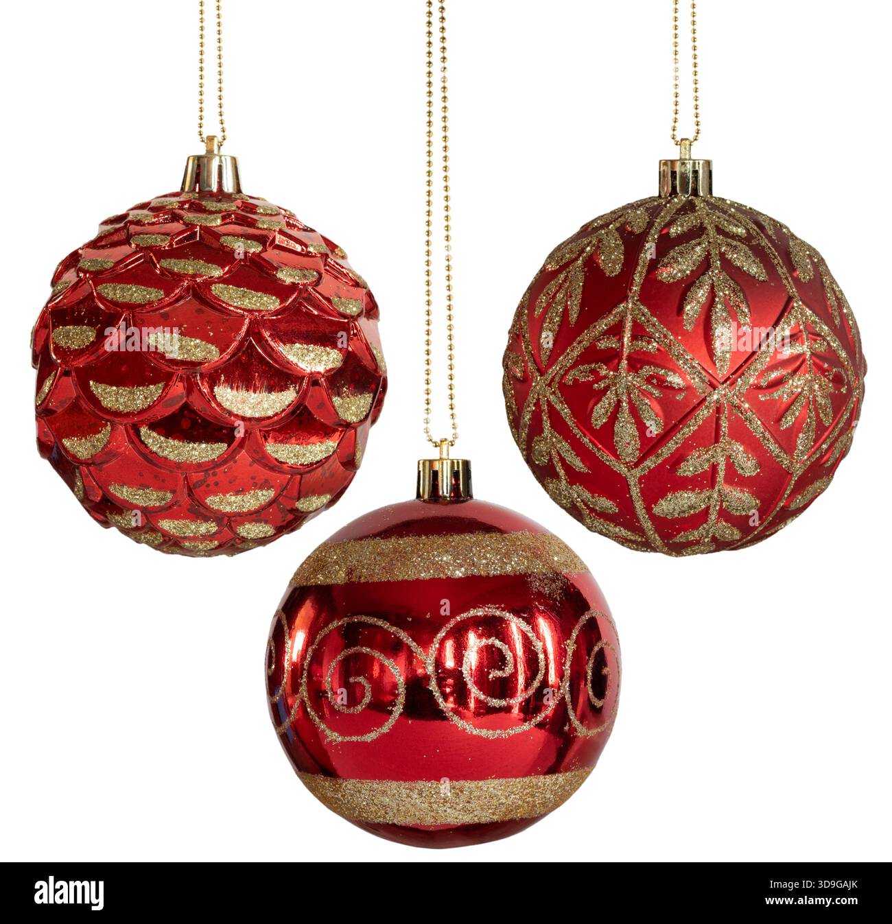 Three gold, yellow and red Christmas tree ornaments hanging on gold ...