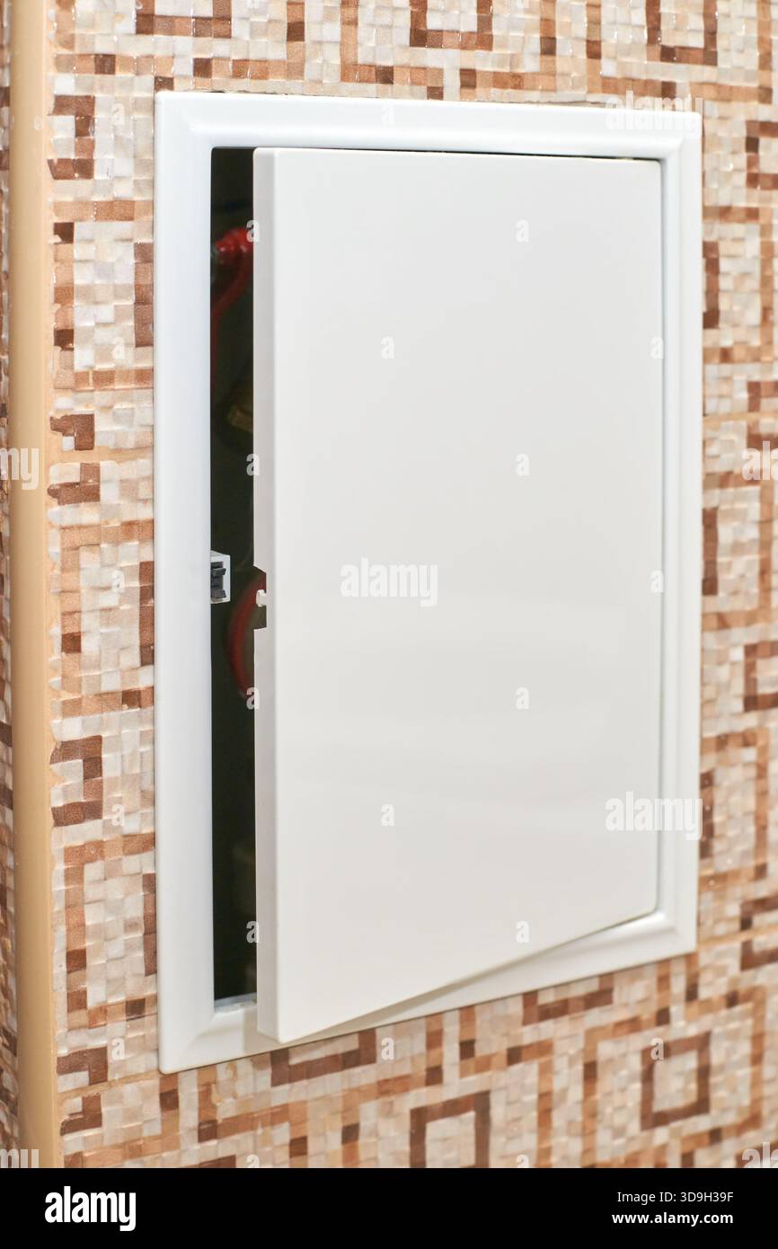 Open electrical panel on tiled wall with geometric pattern showing ...