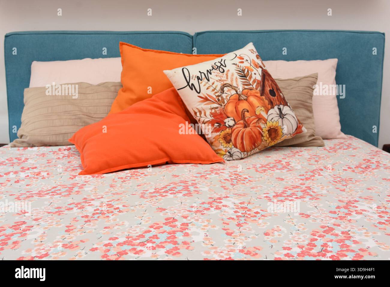 cushions representing autumn placed on the bed Stock Photo