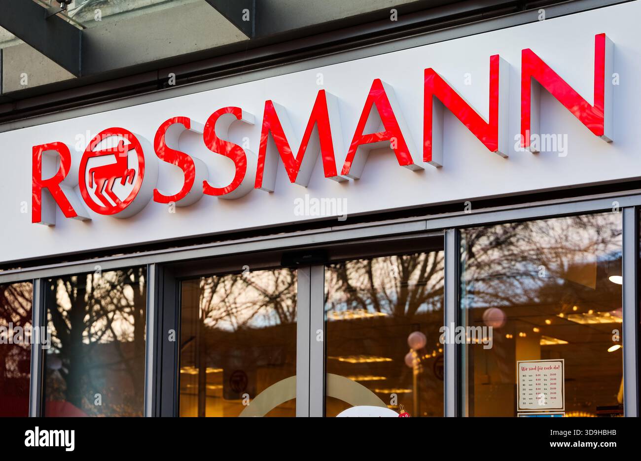 Kiel, Germany - 01. December 2025: Rossmann logo and red signage on modern drugstore facade in Kiel, reflecting urban streetscape and contemporary ret Stock Photo