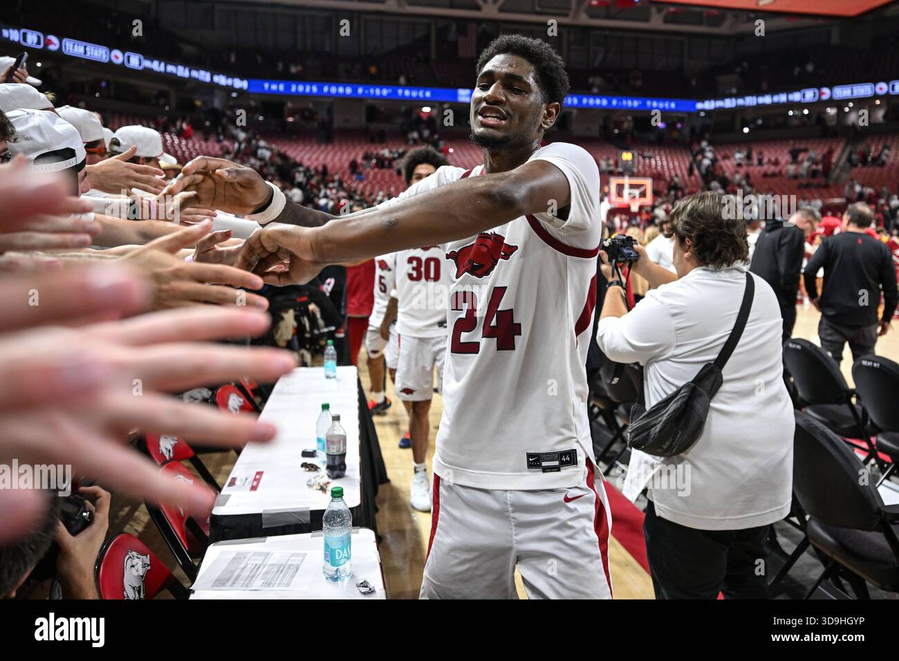 Arkansas guard billy richmond iii celebrates with fans after defeating louisville during an ncaa college basketball game wedn