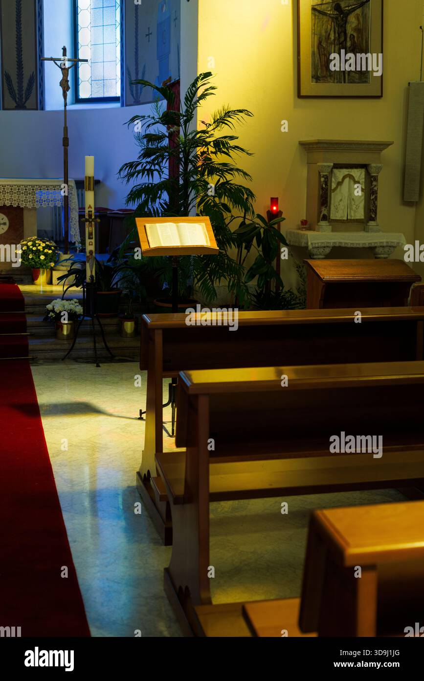 Interior of the church with long rows of old wooden pews. Quiet ...