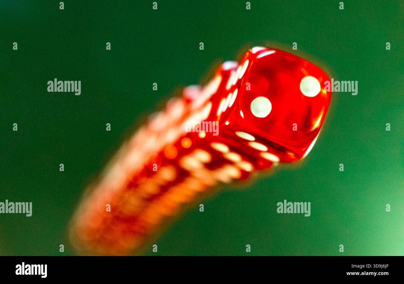 red dice  on a green background, close up Stock Photo