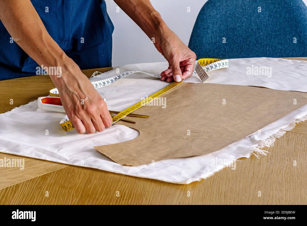 Fashion designer measuring pattern for new dress design Stock Photo - Alamy