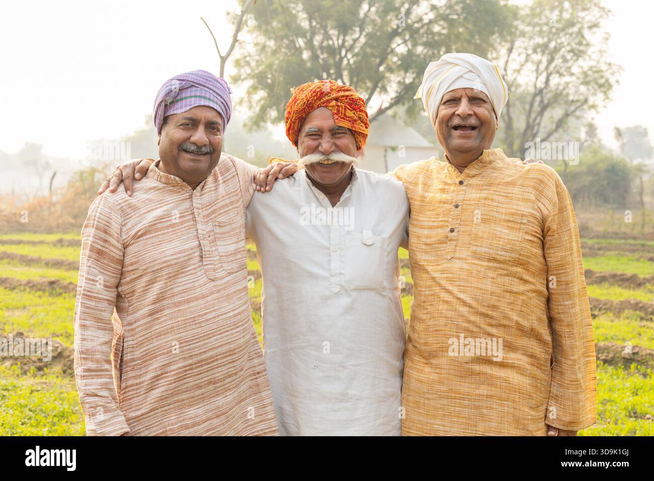 Happy rural indian farmers standing at agriculture field. Smiling ...