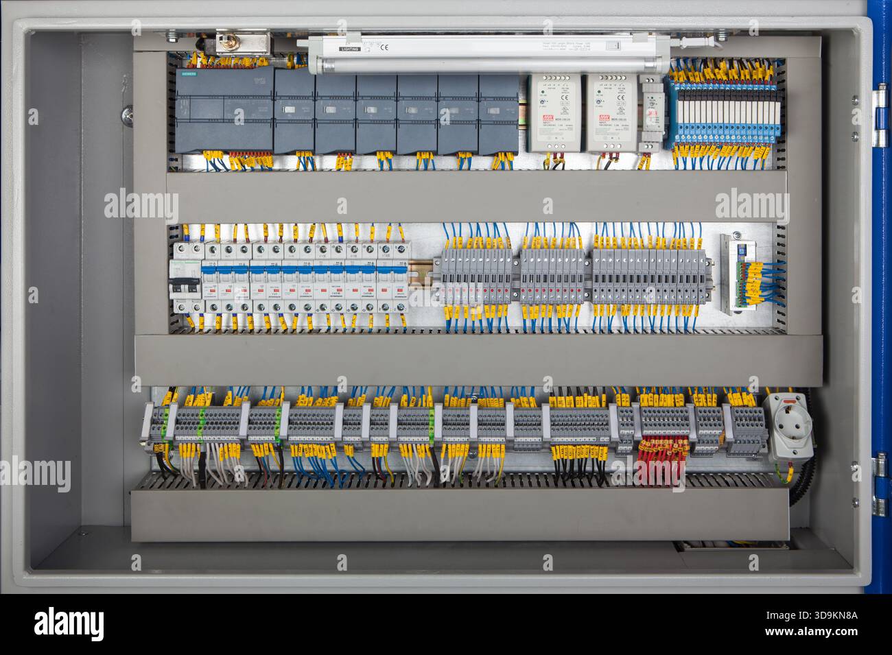 Colorful wires connect to a professional electrical terminal box with switches, fuses, and connectors for various electrical elements. Stock Photo