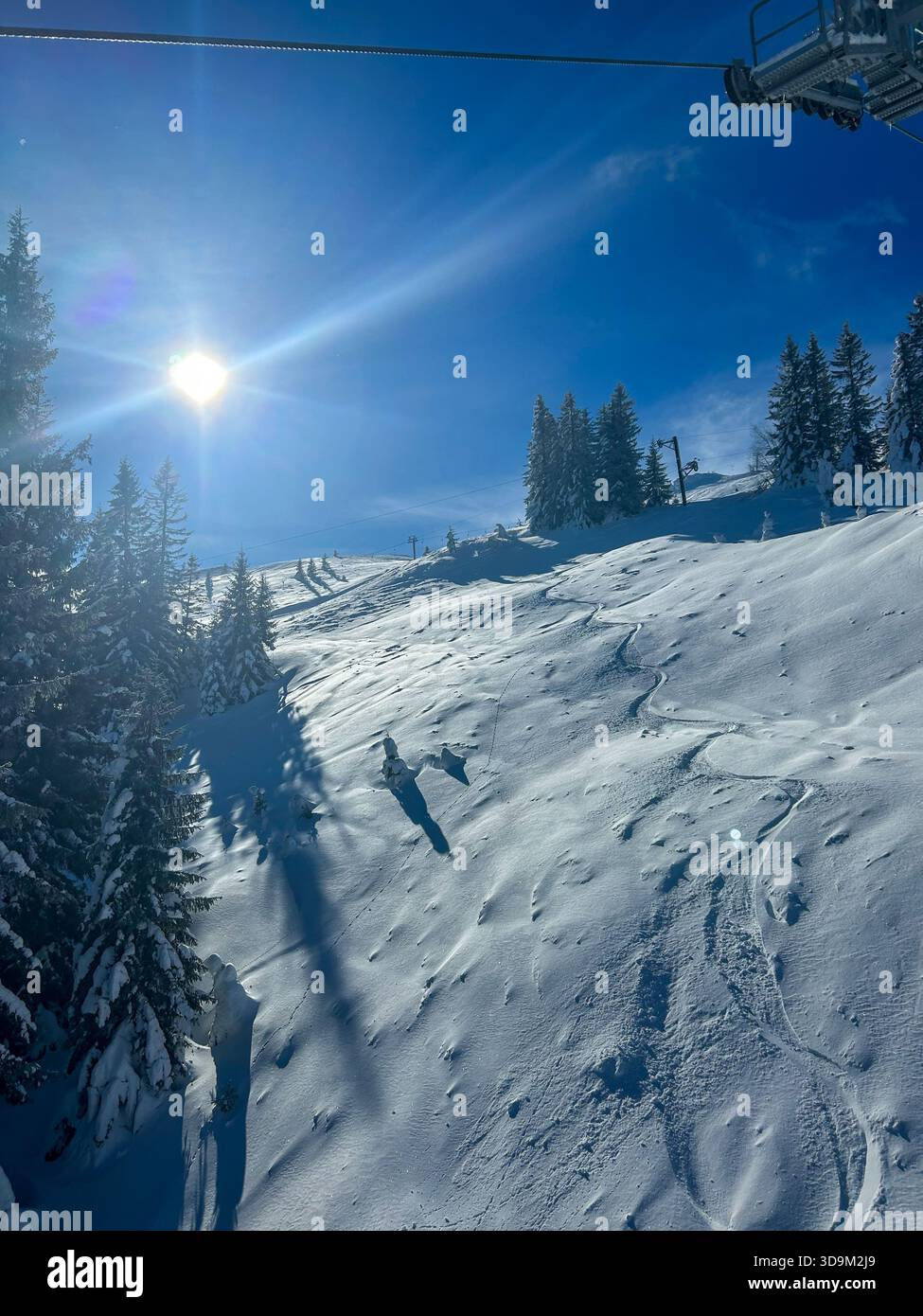 A bright winter day on Jahorina Mountain with fresh snow, long shadows, and clear blue skies, capturing the beauty of a sunny alpine scene. - Smartphone Captured Stock Image