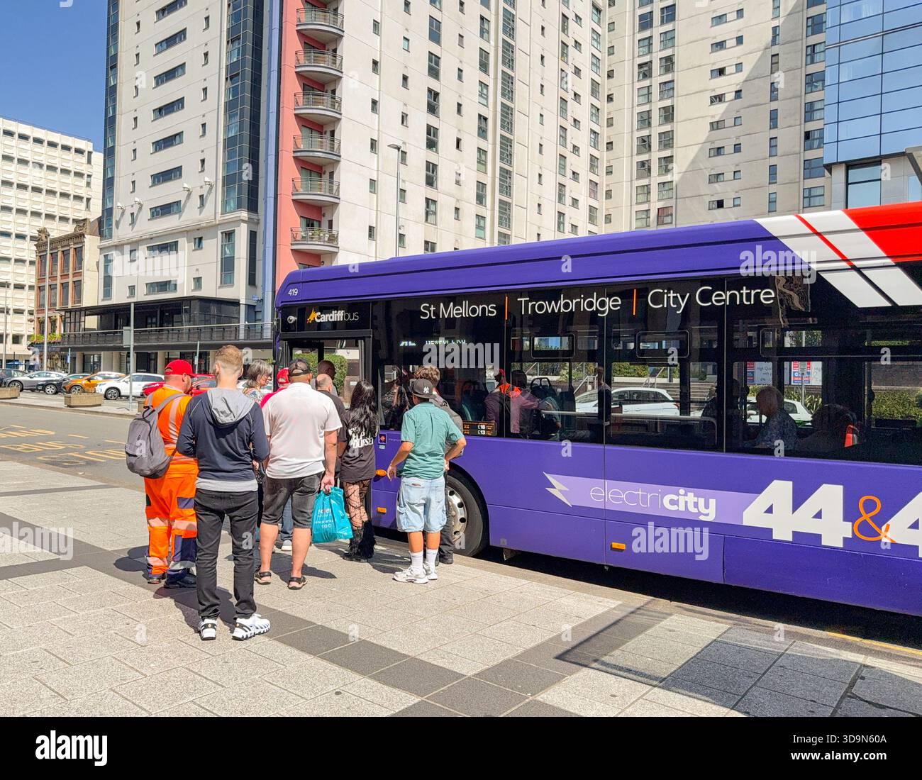 Cardiff, Wales, UK - 15 August 2025: People catching an electric public service bus in Cardiff city centre. The vehicle is operated by Cardiff Bus. - Smartphone Captured Stock Image