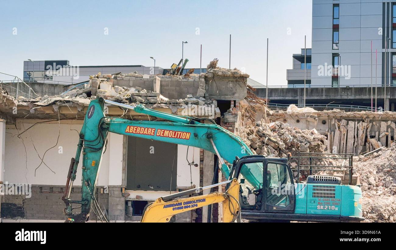 Cardiff, Wales, UK - 15 August 2025: Excavators on a construction site demolishing an old office block in cardiff city centre - Smartphone Captured Stock Image