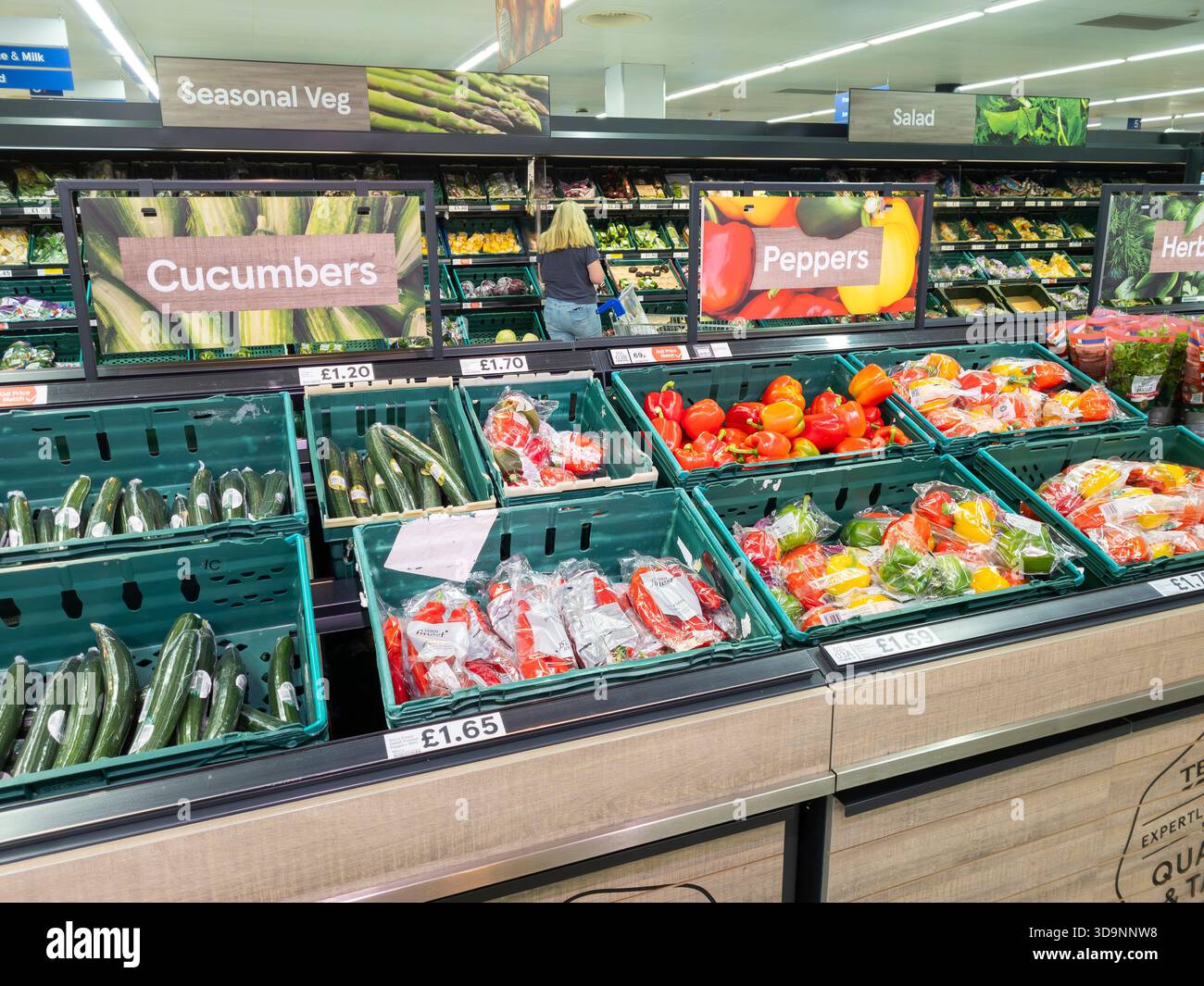 Fresh fruit & vegetables at Faringdon Tesco, with cucumbers and peppers on sale, UK. Concept: plastic packaging, waste plastic, synthetic chemicals - Smartphone Captured Stock Image
