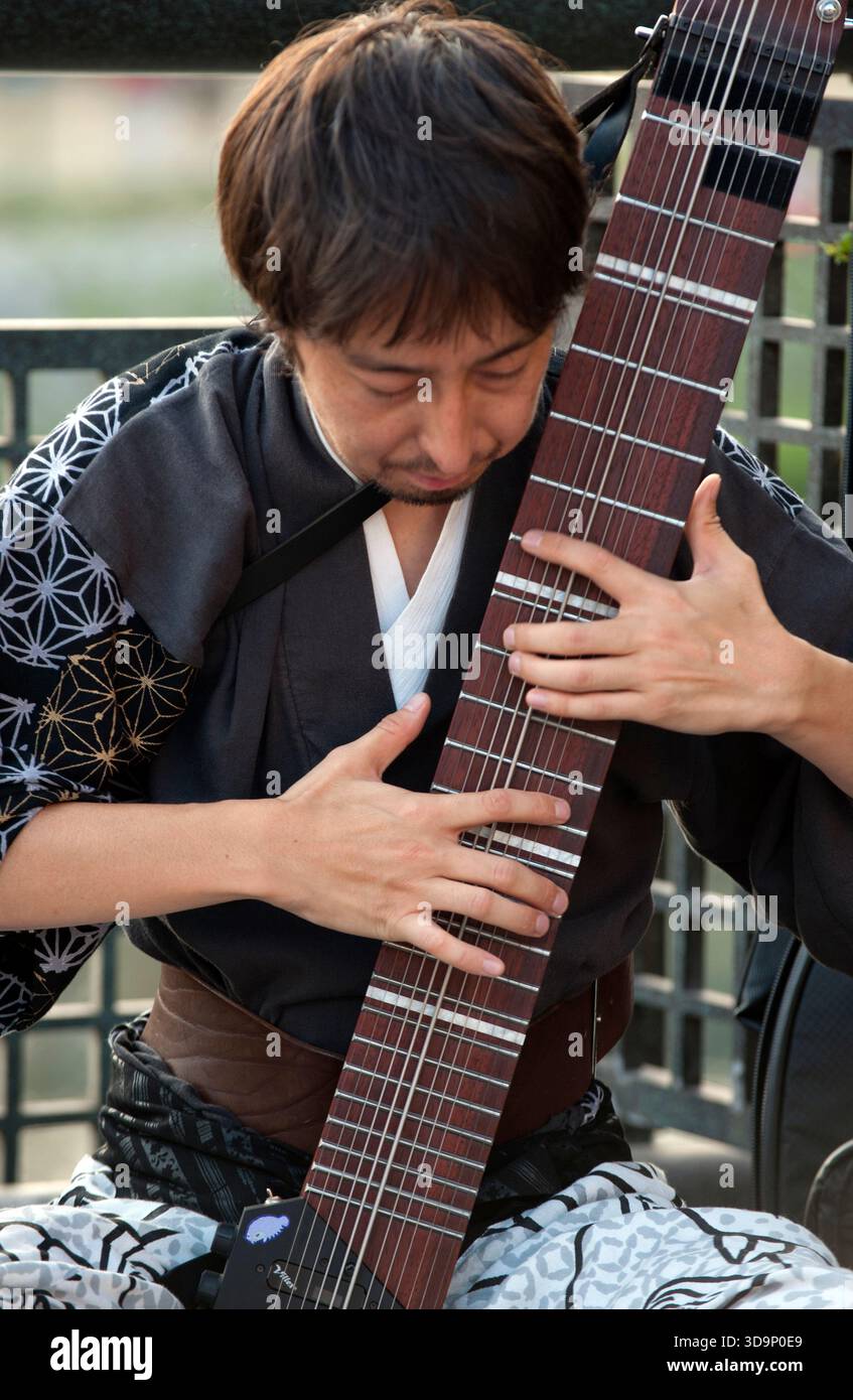 Japanese man playing Chapman Stick: electric musical instrument by ...