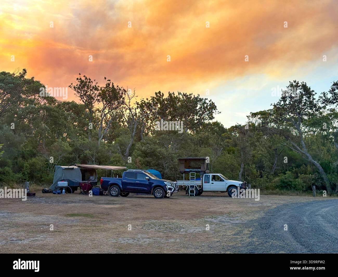 Australian bush fire, summer 2025 bushfire at Bulahdelah on the mid north coast of NSW, spreads smoke and orange sky over campground Myall Lakes - Smartphone Captured Stock Image