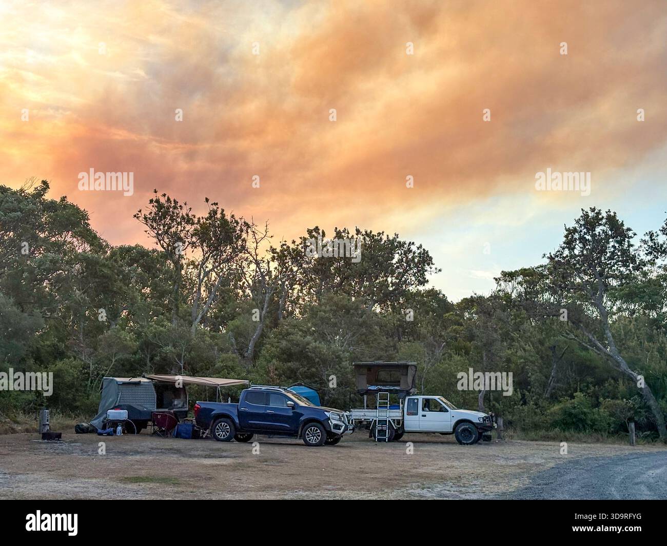 Australian bush fire, summer 2025 bushfire at Bulahdelah on the mid north coast of NSW, spreads smoke and orange sky over campground Myall Lakes - Smartphone Captured Stock Image