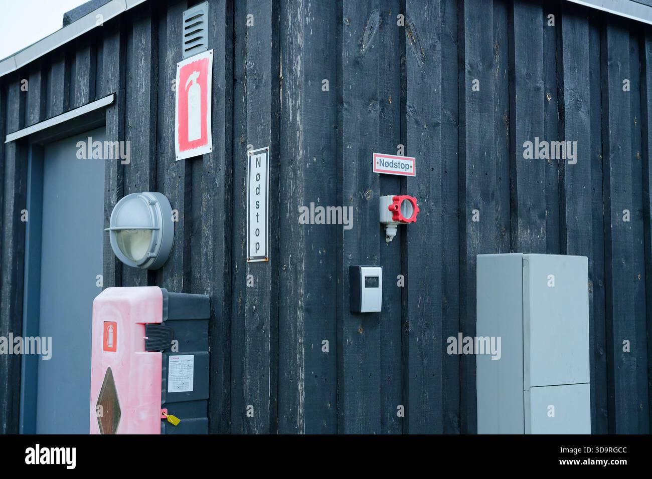 A dark wooden structure with metal door, gas mask symbols, security ...