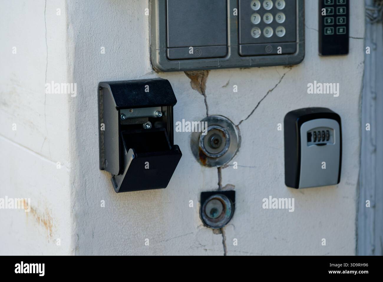 Two key safes, old doorbells, a pair of small keys, and an intercom are ...