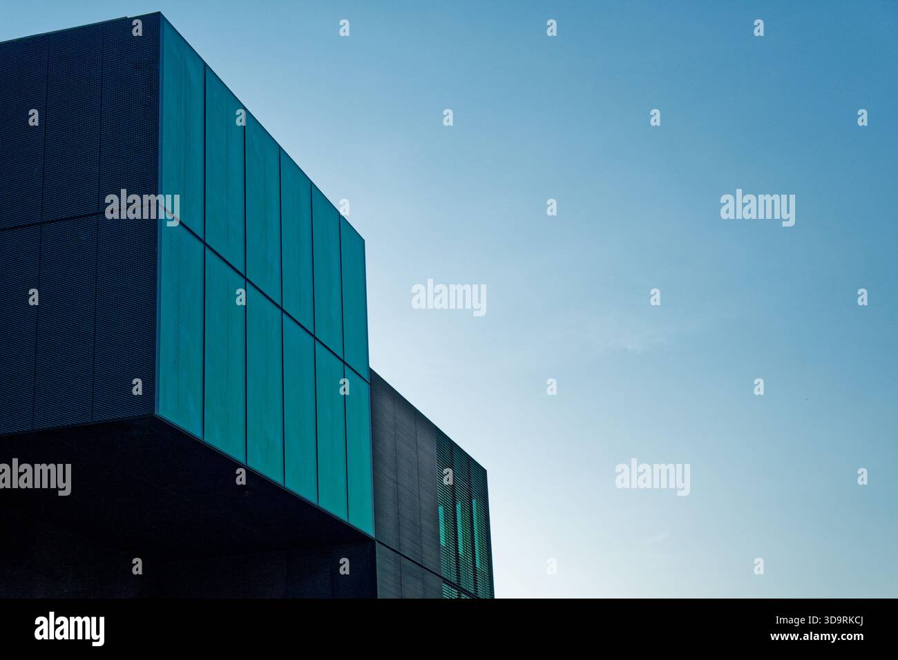 A modern structure with a dark graphite green facade and a black side ...