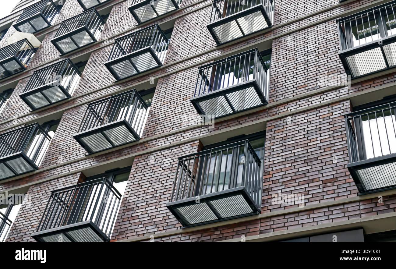 Photo inspiration: Chic Metallic Apartment Buildings Reference: Modern Brick Apartment Building With Metal Balconies Stock Photo