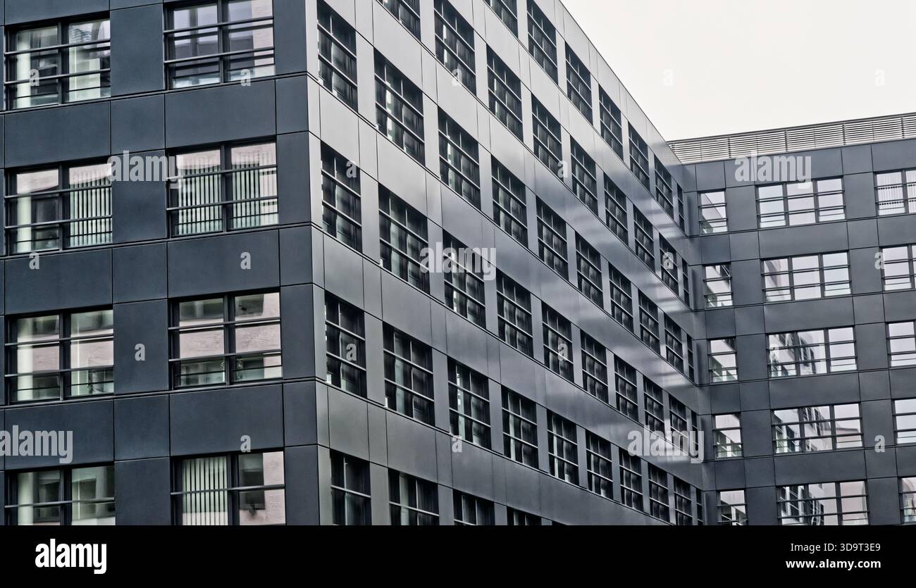 Modern office building with glass windows and metal facade Stock Photo ...