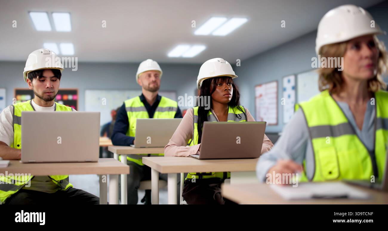 Young Students In University Classroom Working On Computers Together Happily Stock Photo