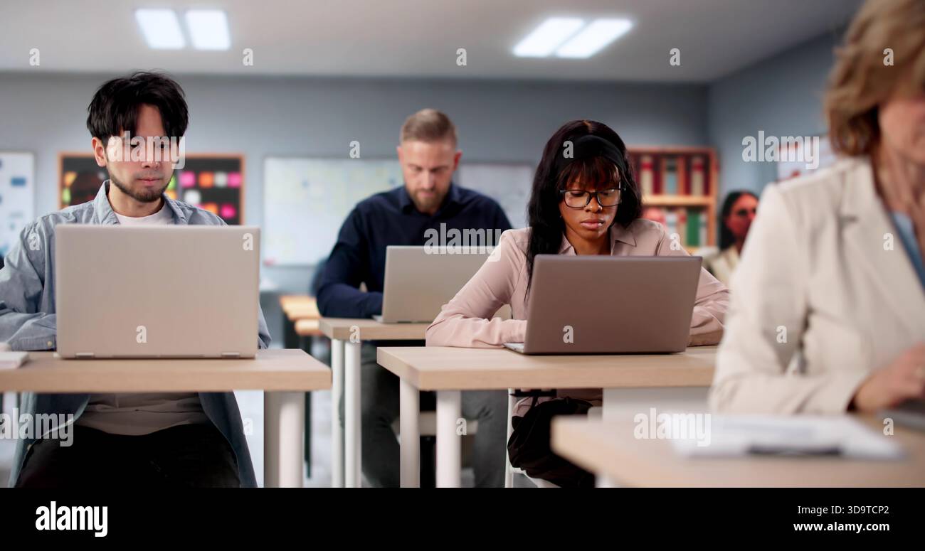 American University Professor Conducts Diverse Student Group Test In Classroom Stock Photo
