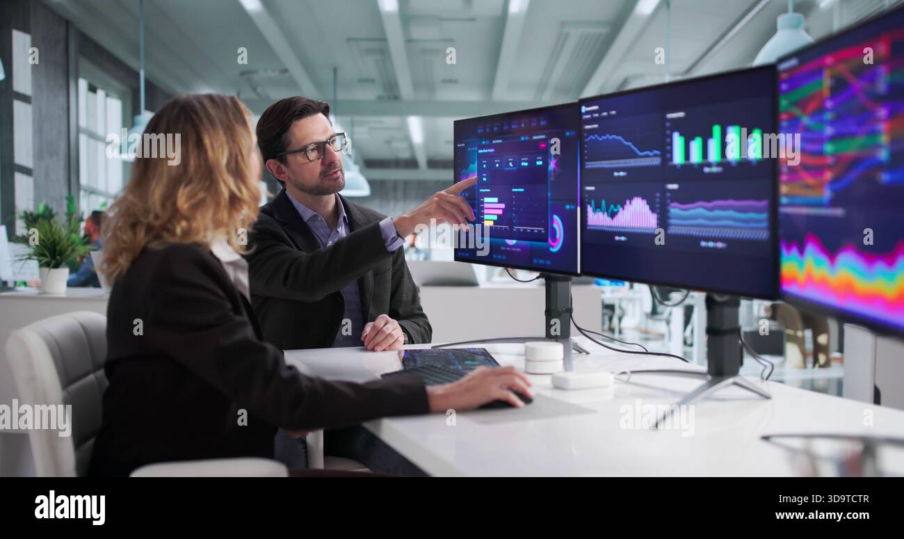 Financial Analysts Analyzing Data On Computer Dashboard For Business Performance. Stock Photo