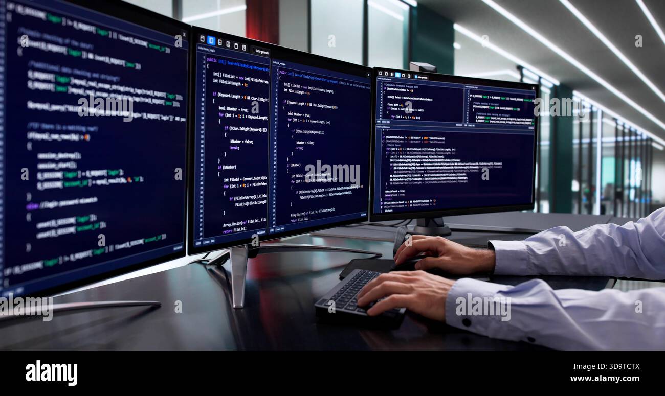 Mid-Age Caucasian Man Developing Cybersecurity Software Code On Computer Screen Stock Photo