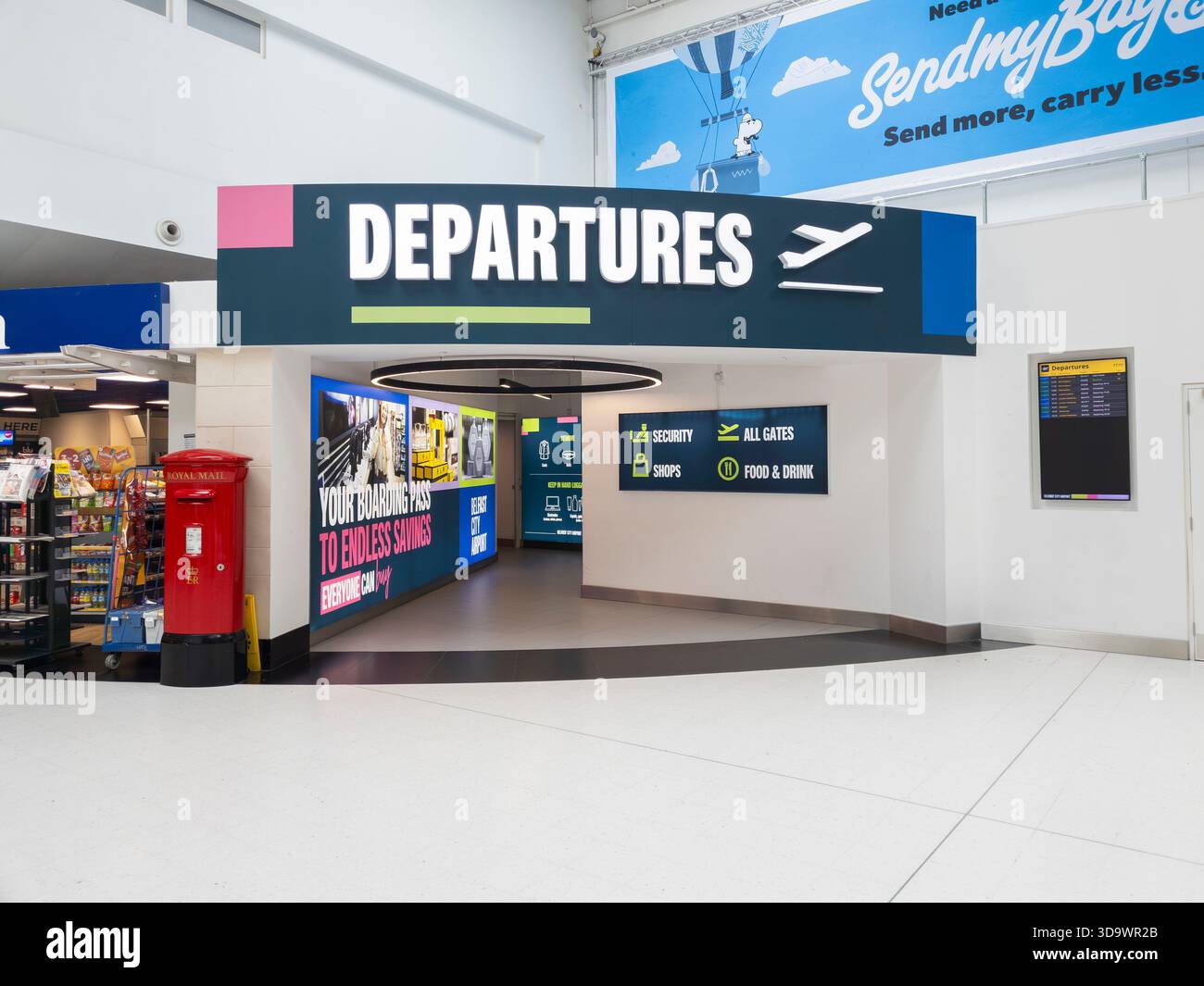 The entrance to flight departures at Belfast International Airport, Northern Ireland. Concept: VINCI Airports, empty airport, passenger numbers - Smartphone Captured Stock Image