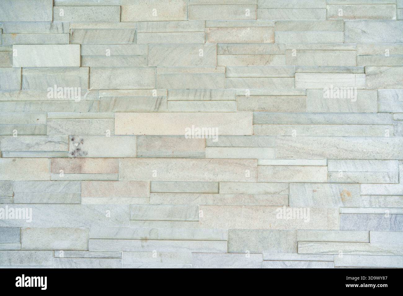 Layered rectangular stacked stone wall with gray color rough natural surface texture background Stock Photo