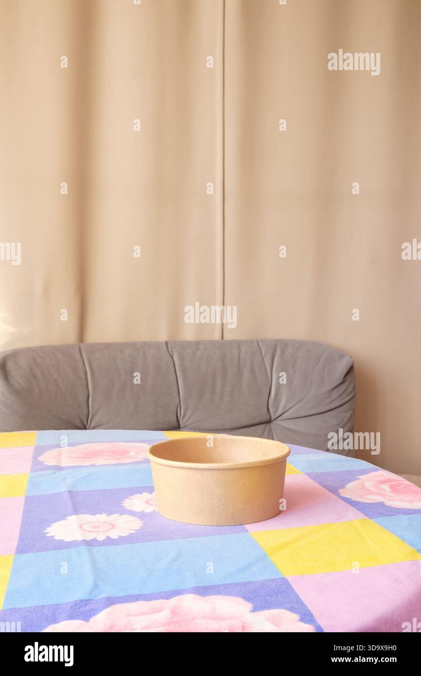 empty cardboard bowl on table with tablecloth Stock Photo