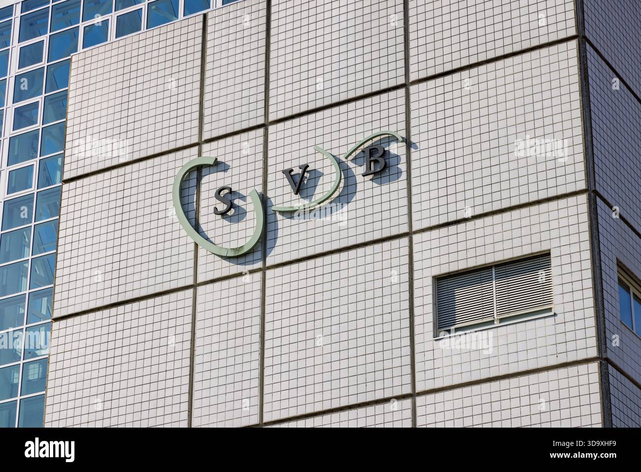 Logo of the SVB (Sociale Verzekeringsbank) mounted on the tiled facade ...