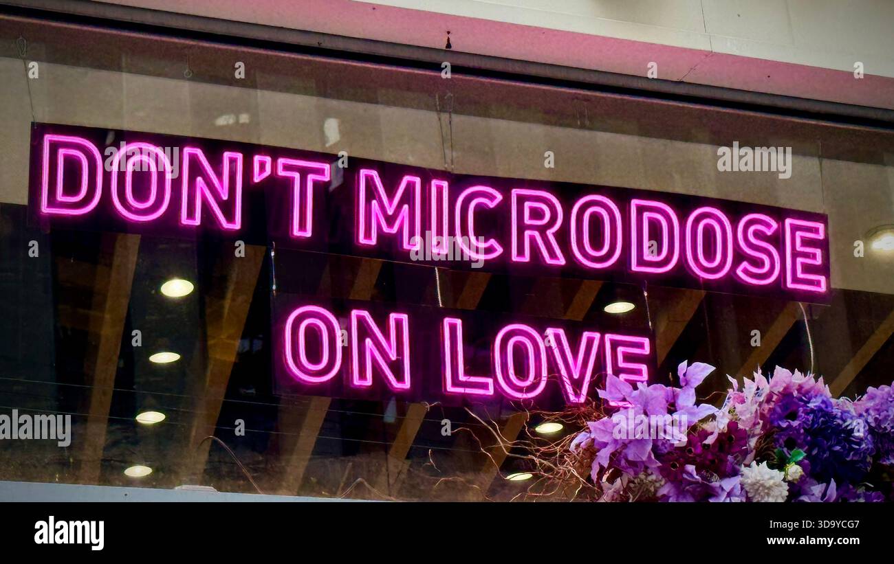 'Don't Microdose On Love' Neon Sign on Broadway, NYC - Smartphone Captured Stock Image