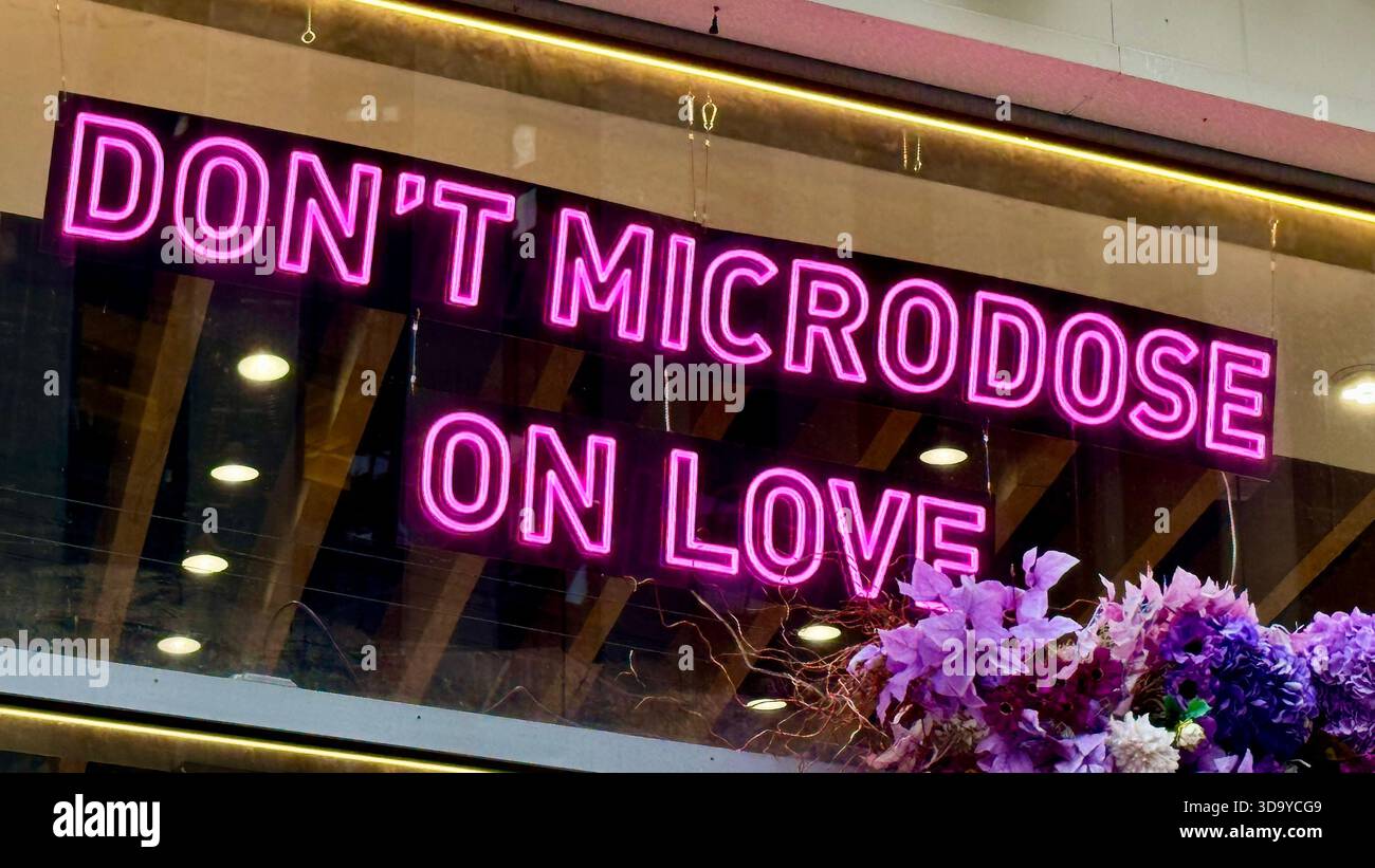 'Don't Microdose On Love' Neon Sign on Broadway, NYC - Smartphone Captured Stock Image