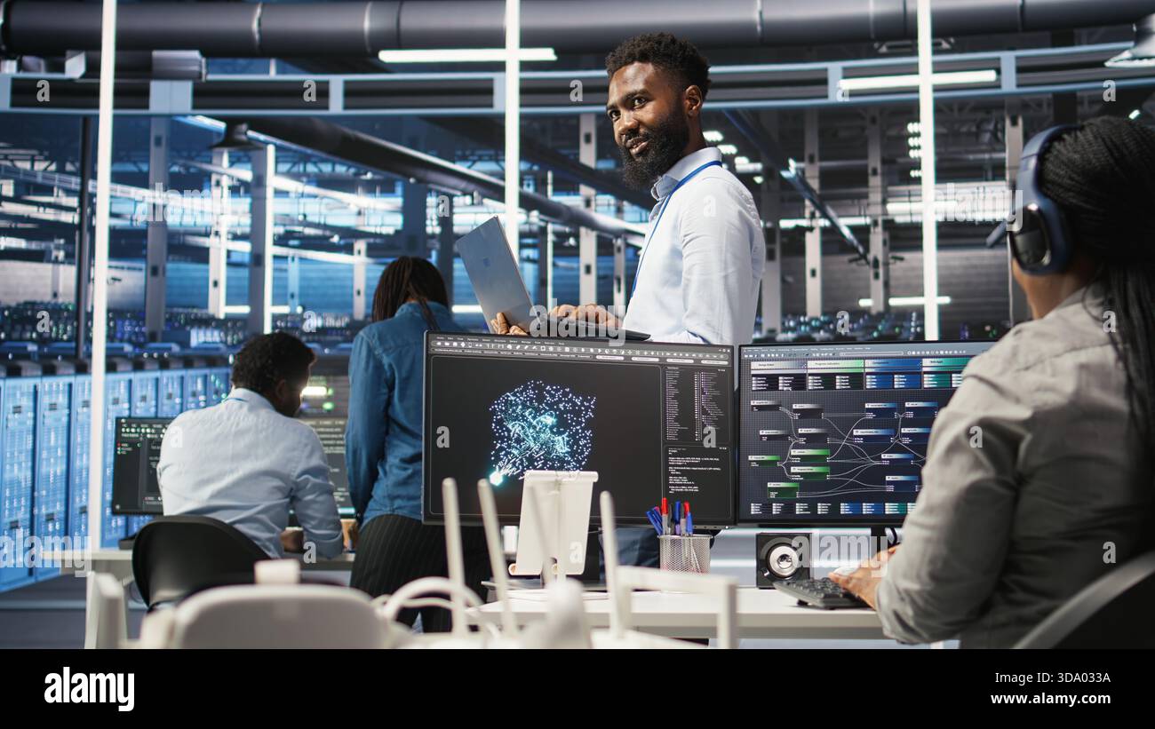 Happy data center admin uses node tree programming on laptop to identify equipment performance issues. Cheerful server farm worker reviews data analysis graph to minimize hardware failures, camera A Stock Photo