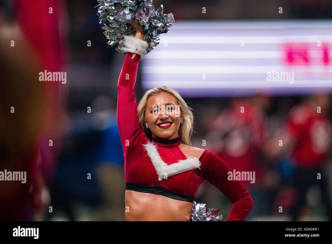 An Atlanta Falcons cheerleader performs before an NFL football game ...