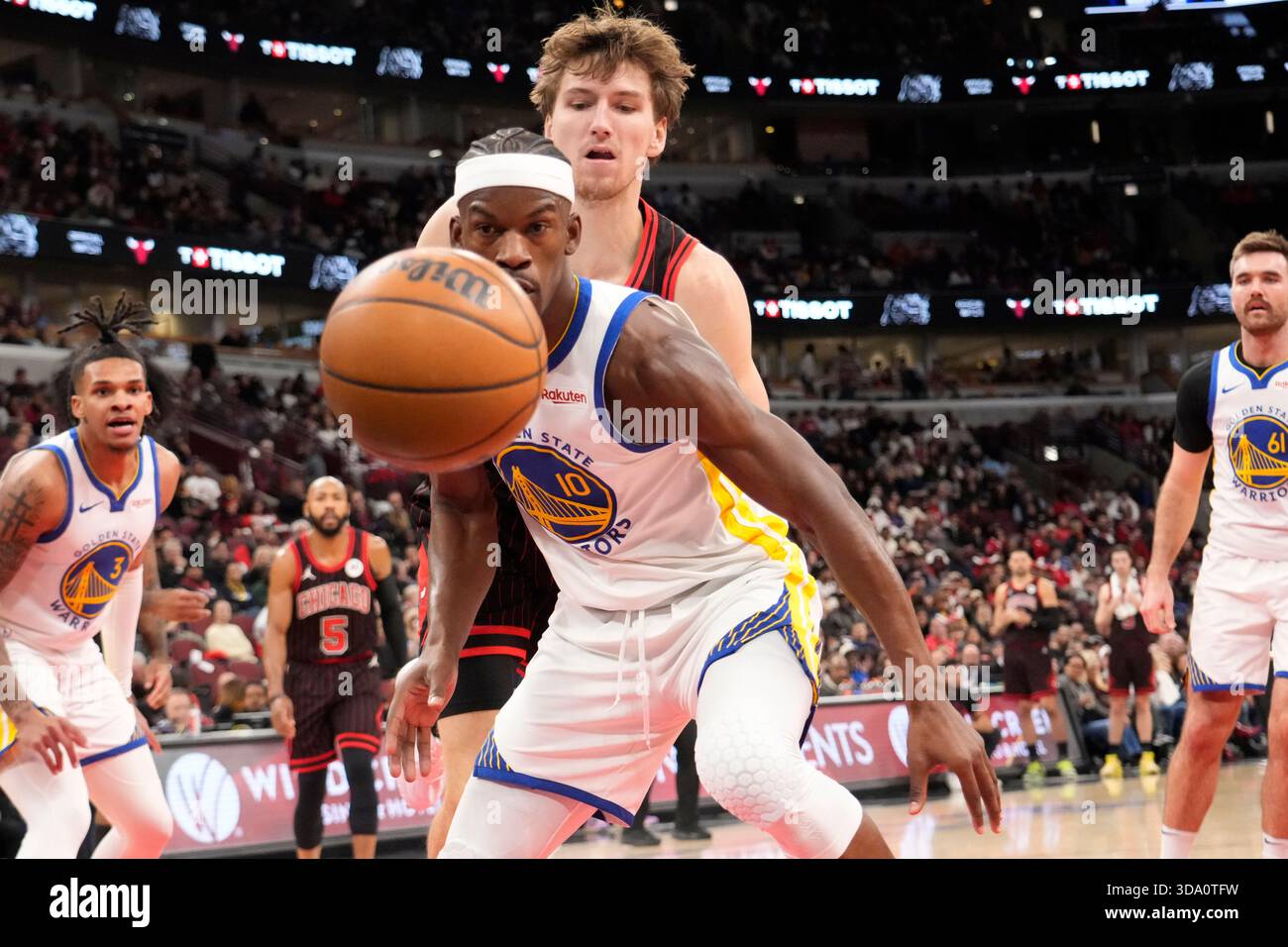 Golden State Warriors forward Jimmy Butler III, front, is defended by ...