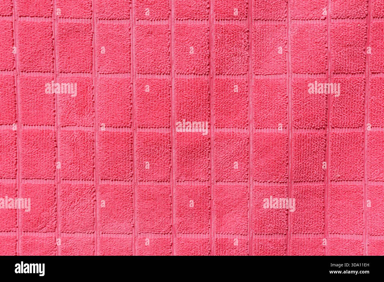 Pink fabric with a grid pattern close-up abstract textured background Stock Photo