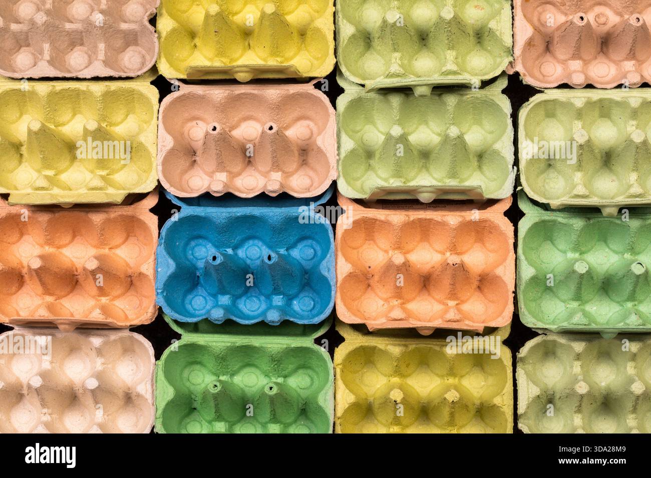 Open empty egg box cartons in different colours, viewed from above in a grid pattern Stock Photo