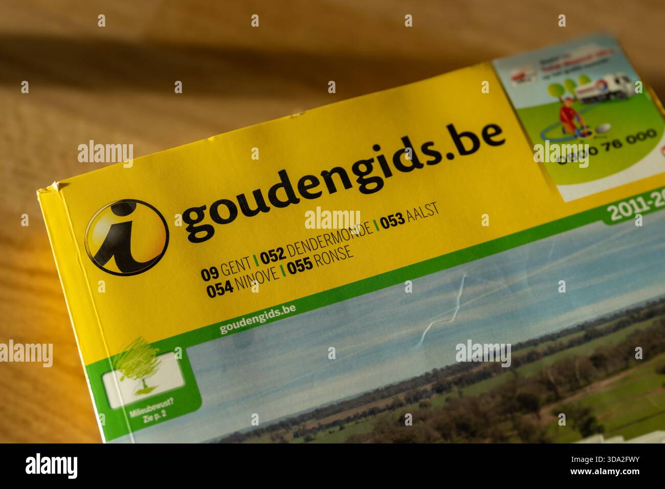 AALST, BELGIUM, 2 DECEMBER 2025: Illustrative editorial image of an obsolete paper phonebook the 'Gouden Gids', the Yellow Pages telephone directory o - Stock Image