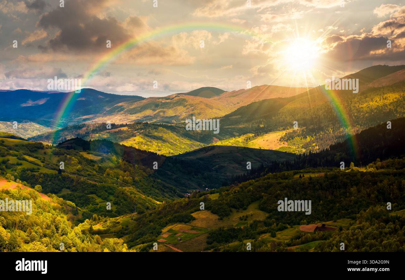 rolling forested hills in spring at sunset. beautiful scenery of mountainous countryside in dappled evening light. leadership corporate wallpaper unde Stock Photo