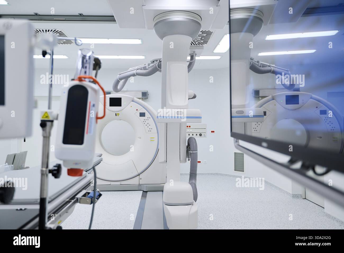 A state-of-the-art medical imaging room featuring a CT scanner ...