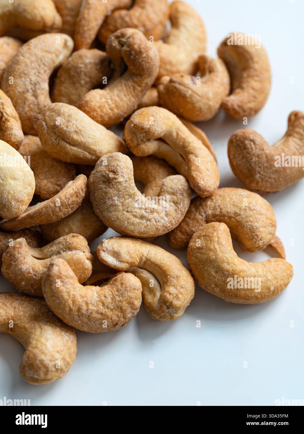 Roasted Cashew Nuts Close-Up on White Background Stock Photo