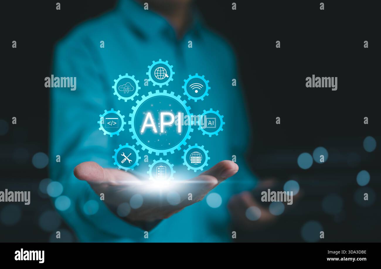 API, Application Programming Interface Concept. A person presents a glowing API (Application Programming Interface) concept surrounded by digital icon Stock Photo