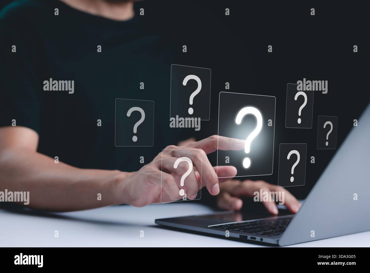 Question Mark and Problem Solving Concept. A person using a laptop with floating question marks, symbolizing brainstorming, problem-solving, and findi Stock Photo