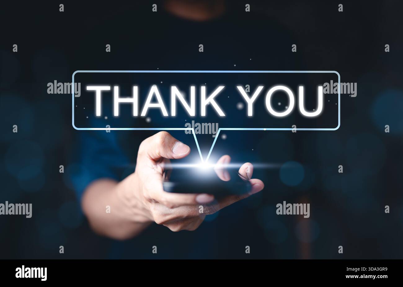Thank you message concept. A person holding smartphone with glowing "Thank You" message, symbolizing appreciation and gratitude digital communication Stock Photo