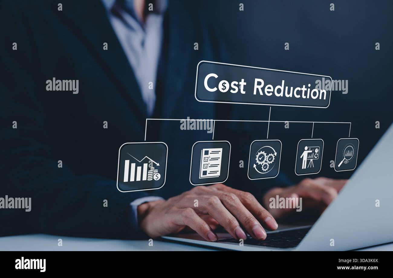 Cost reduction concept. Cost wording on decreasing coins stacking with the down arrow. Businessman working on company cost saving. Cost Management, Ec Stock Photo