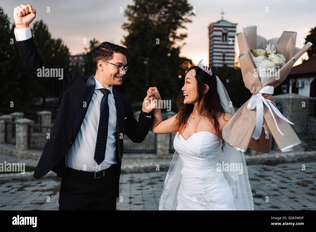 Happy multicultural wedding couple dancing celebrating marriage Stock Photo