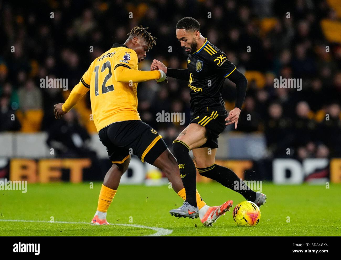 Wolverhampton Wanderers' Emmanuel Agbadou (left) and Manchester United ...
