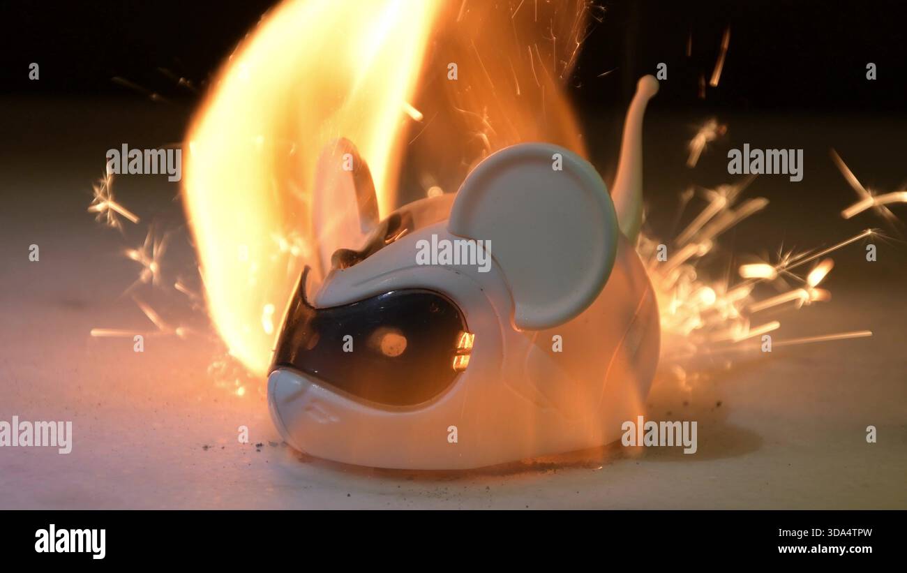 The plastic toy starts to burn, flashes, sparks and intense glow appear Stock Photo