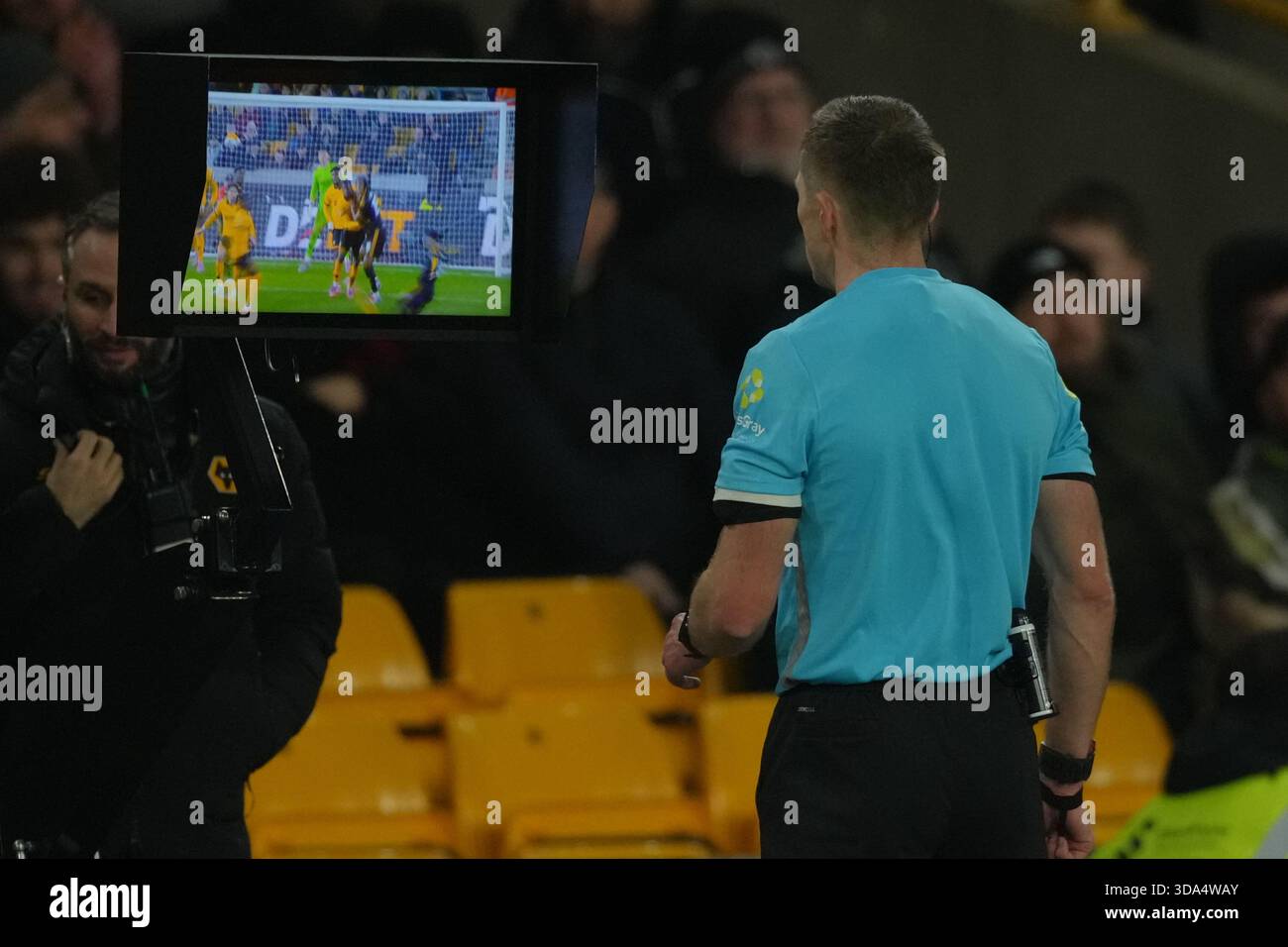 Areferee checks video for a possible penalty kick during the Premier ...