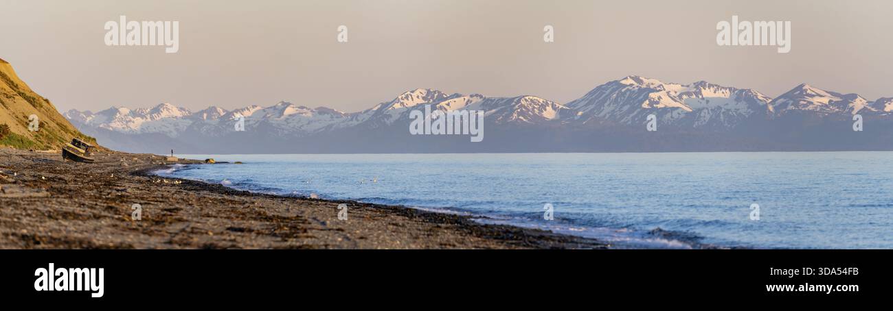 Point Inlet Alaska Boat on Anchor Point beach on Cook Inlet in the evening light, snowy ...